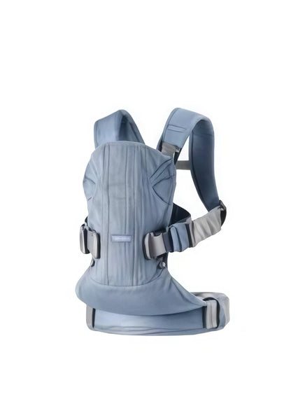 Light blue BabyBjörn Carrier One Cotton baby carrier with breathable cotton fabric, wide waist belt, and ergonomic support for comfortable babywearing.