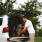 A man loading the easily foldable Segway ZT3 Pro electric scooter into the trunk of a car, highlighting its portability and convenience.