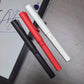 Close-up of LAMY Safari Note+ digital pens in black, red, and white with caps on, arranged diagonally over an iPad screen displaying cursive handwriting. Designed for natural grip, precision, and everyday use.