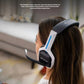 Side view of a gamer wearing the white-and-blue ASTRO A20 headset, showing the flip-to-mute boom mic extended for clear in-game communication.