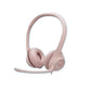 Soft rose-colored Logitech H390 headset with matching boom mic, isolated on white.
