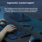 Lifestyle photo of hands typing on the MX Keys S keyboard with the soft memory-foam palm rest, MX Master 3S mouse, and wireless earbuds on a dark wood desk.