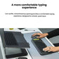 Side-angle lifestyle photo of the black POP Icon Combo in use beside a laptop, illustrating the ergonomic low-profile key design and quiet keystrokes.
