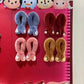 Display of multiple OSIM uSnooz massage wraps in various colors and Disney Tsum Tsum characters including Minnie Mouse, Donald Duck, Chip & Dale, and Daisy Duck. Showcased in a retail setting with vibrant lighting.
