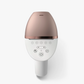 Image of a handheld IPL (Intense Pulsed Light) hair removal device in a sleek white and rose gold design. The device comes with three interchangeable attachment heads for different body areas, each designed with specialized treatment windows. The attachments are color-coded for easy identification and suited for face, body, and precision areas