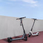 The Segway E2 Plus electric KickScooter shown in both black and white color options, parked side-by-side on a colored path.