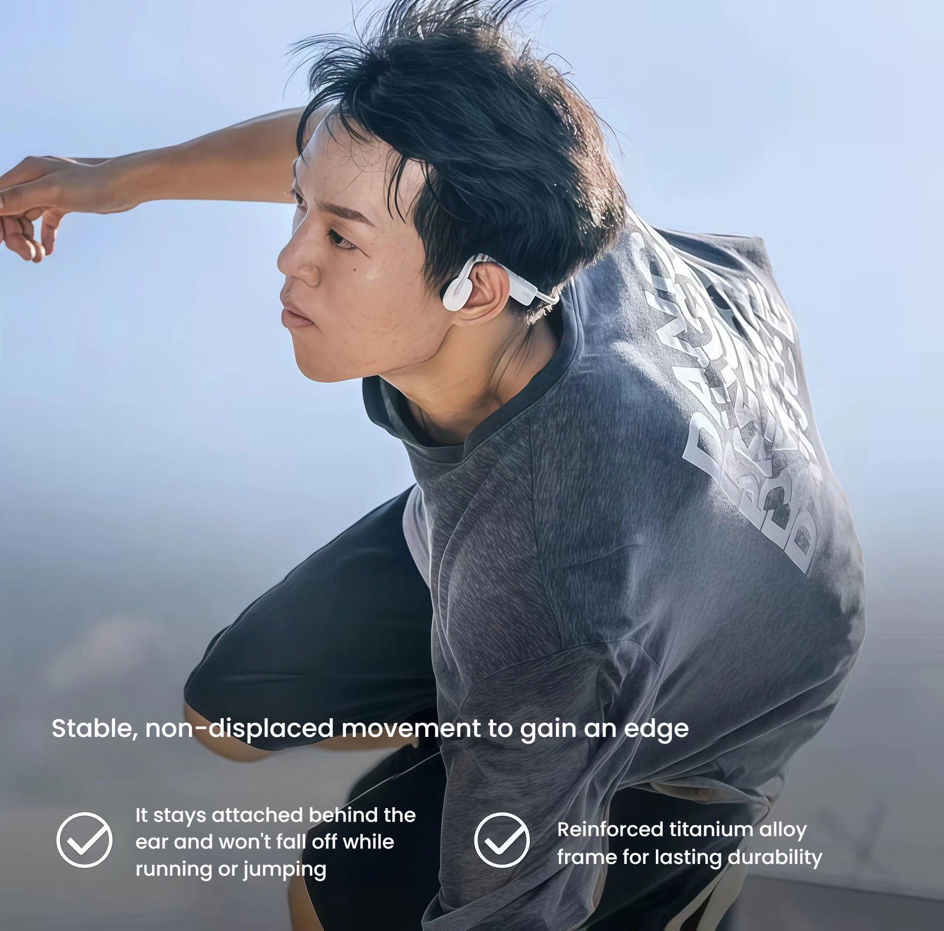 Man running outdoors with Shokz OpenMove headphones securely attached behind the ear — reinforced titanium alloy frame ensures durability and non-slip fit during motion.