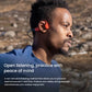 Man running outdoors wearing Shokz OpenSwim Pro bone conduction headphones, enjoying open-ear sound with environmental awareness