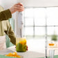 Mother using Philips Avent handheld blender to make smooth baby food from steamed vegetables like pumpkin and zucchini—safe, fast, and mess-free.